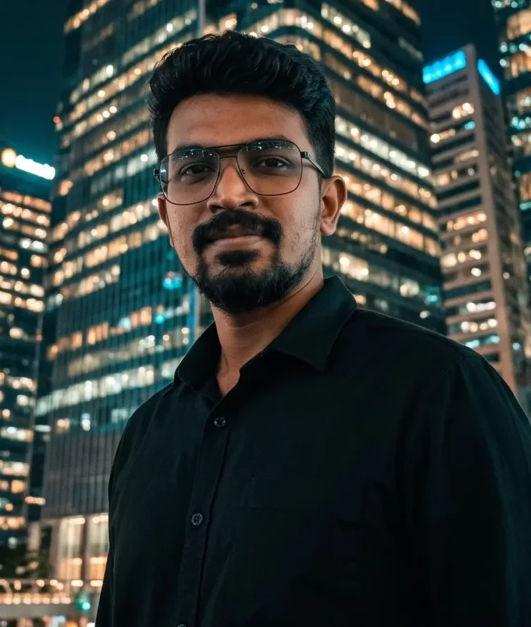 Close portrait of the founder looking up at lit skyscrapers in a China business district at night