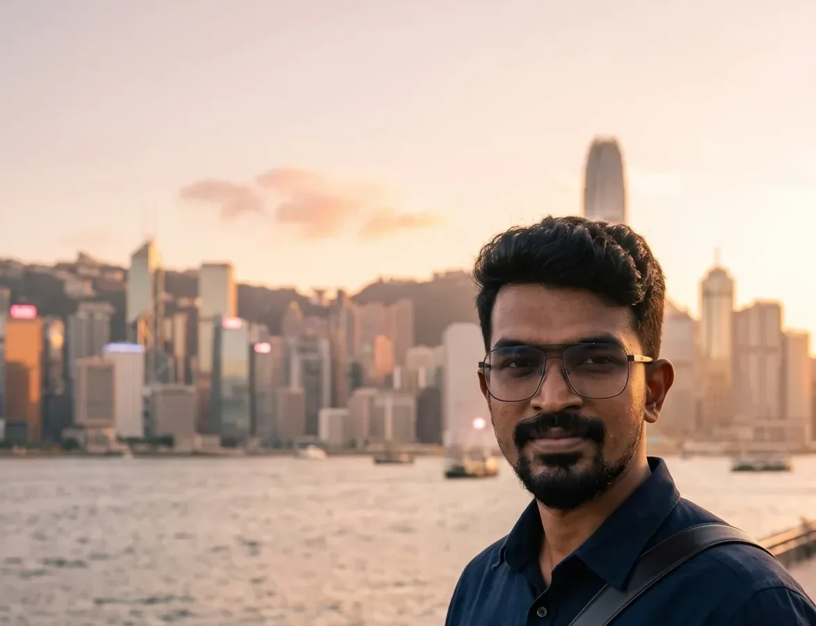 Panorama of the Hong Kong skyline across the harbour in golden hour light with the founder at right