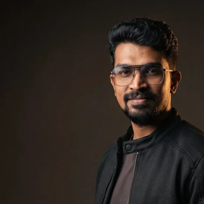 Close studio portrait of a performance marketer against a dark backdrop with warm light